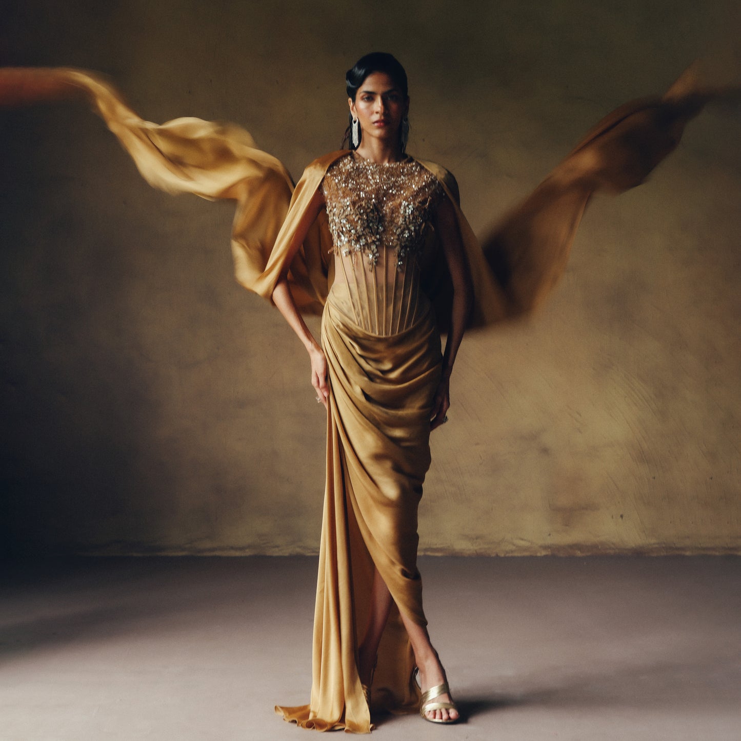 Embroidered corset with draped gown skirt in golden coffee brown against a neutral background